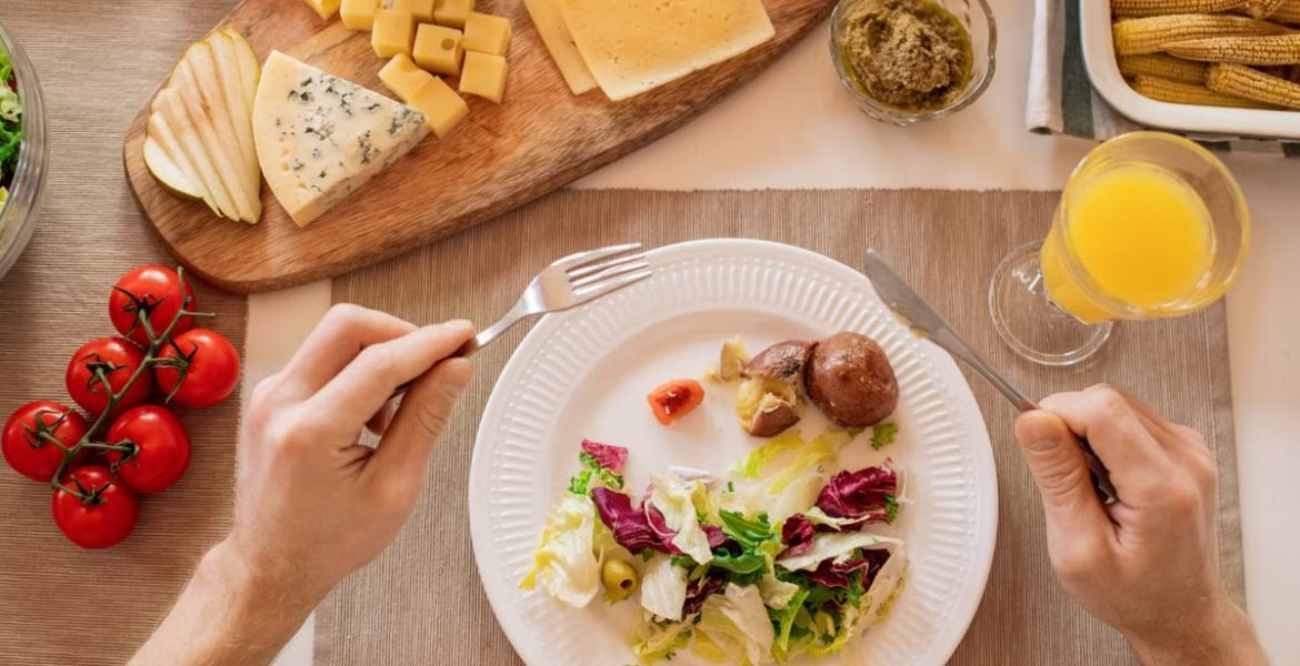 A vibrant lunch setting with salad, cheese, and orange juice, perfect for a healthy meal.